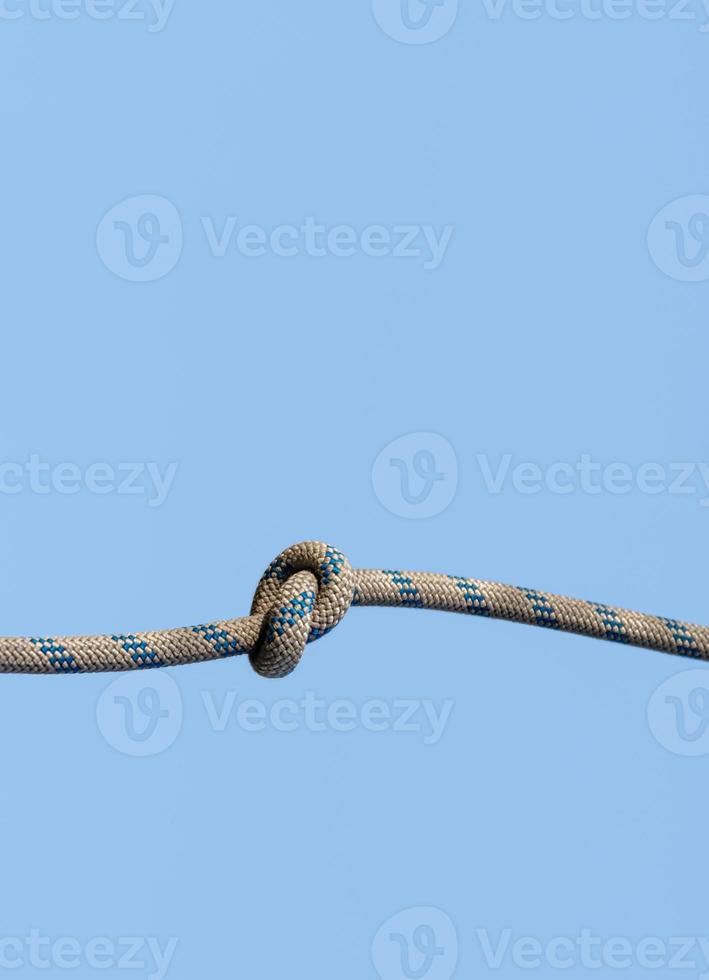 lots of ropes and a big knot against the blue sky photo