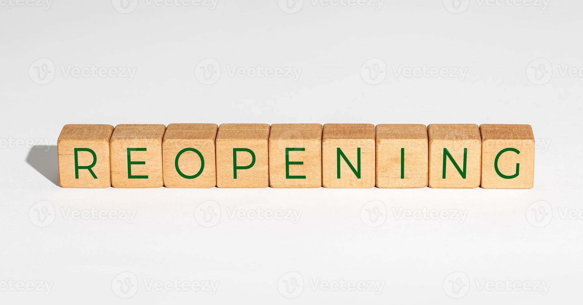 Reopening concept after the coronavirus pandemic. Wooden blocks with text isolated on white background photo