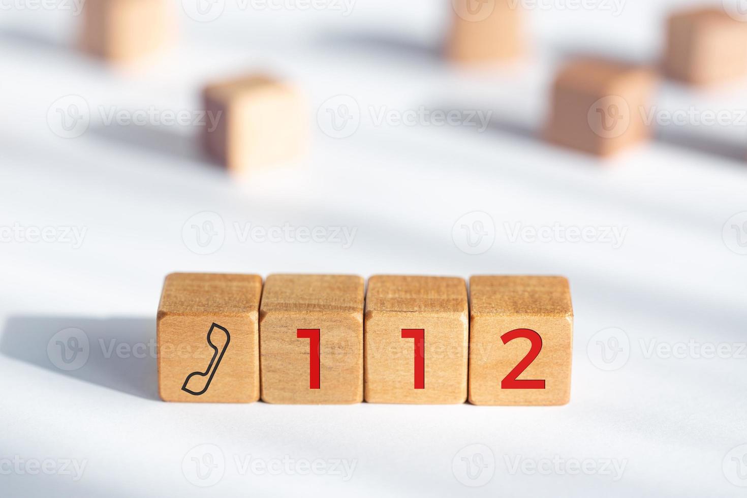 112 emergency concept. Wooden dices with phone icon and 112 text photo