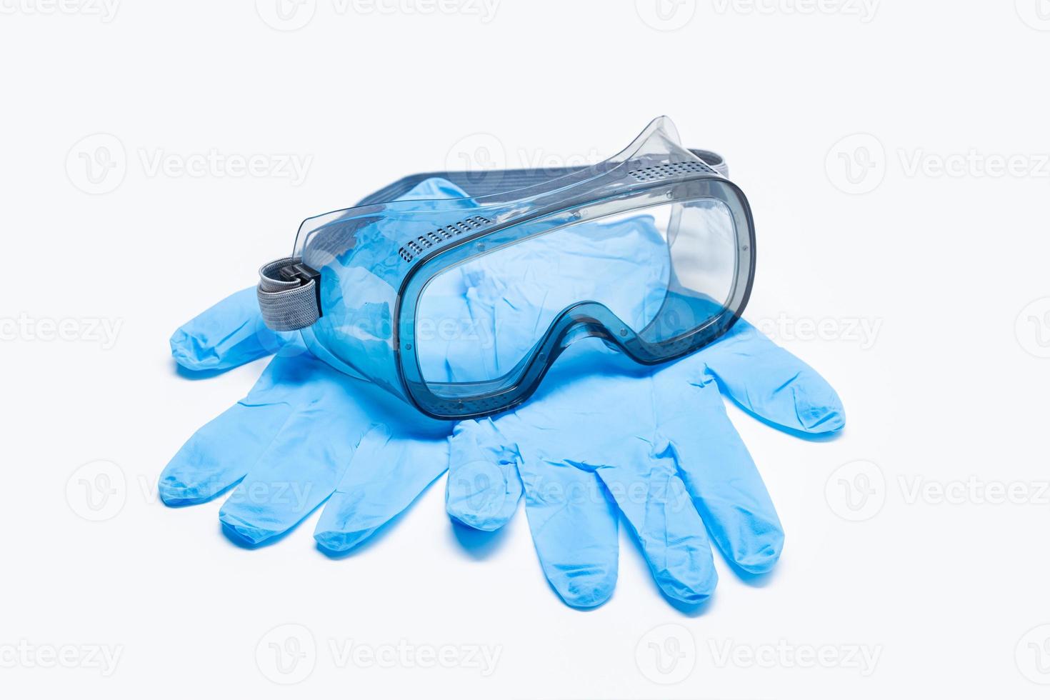 Medical gloves and protective glasses isolated on white background photo