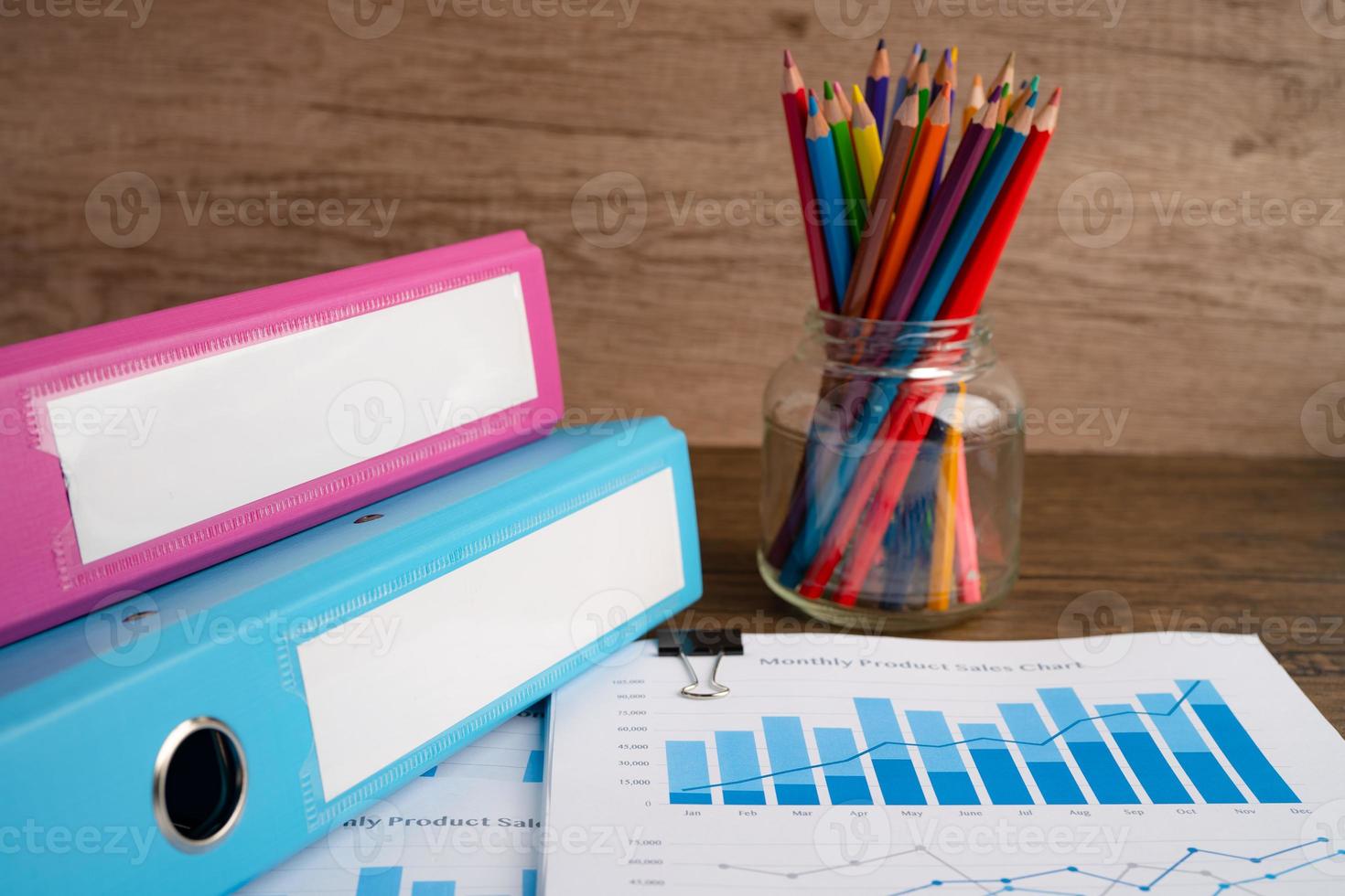 Binder data finance report business and colorful pencil with graph analysis in office. photo