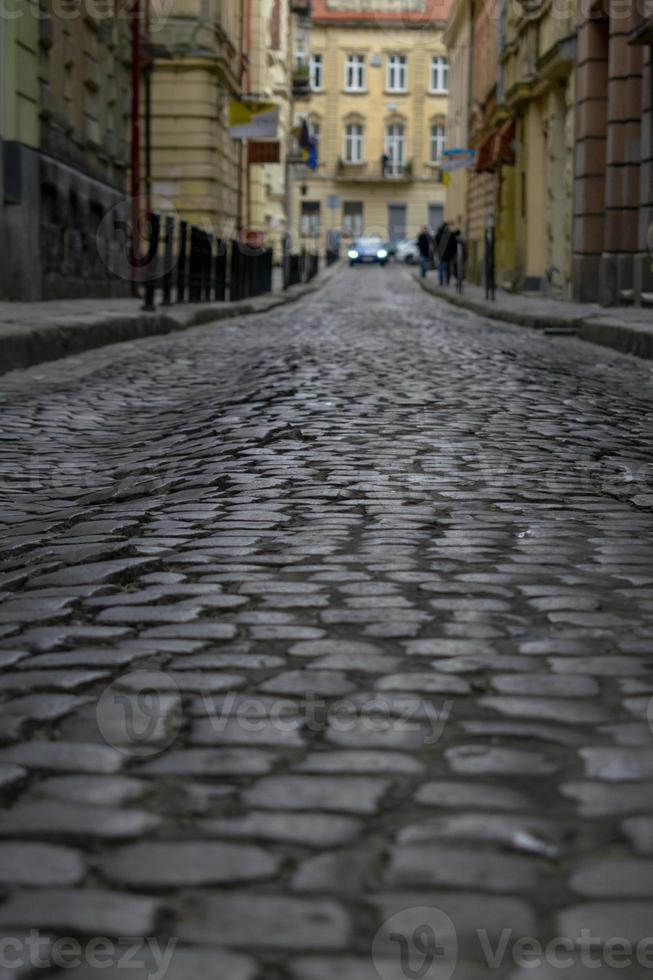 Old cobbled high street with selective focus on cobble stones photo