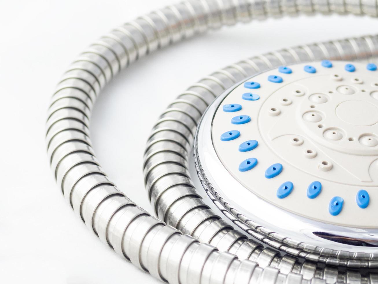 closeup of water shower material and metal cable spiral pipe in bathroom. on white background photo