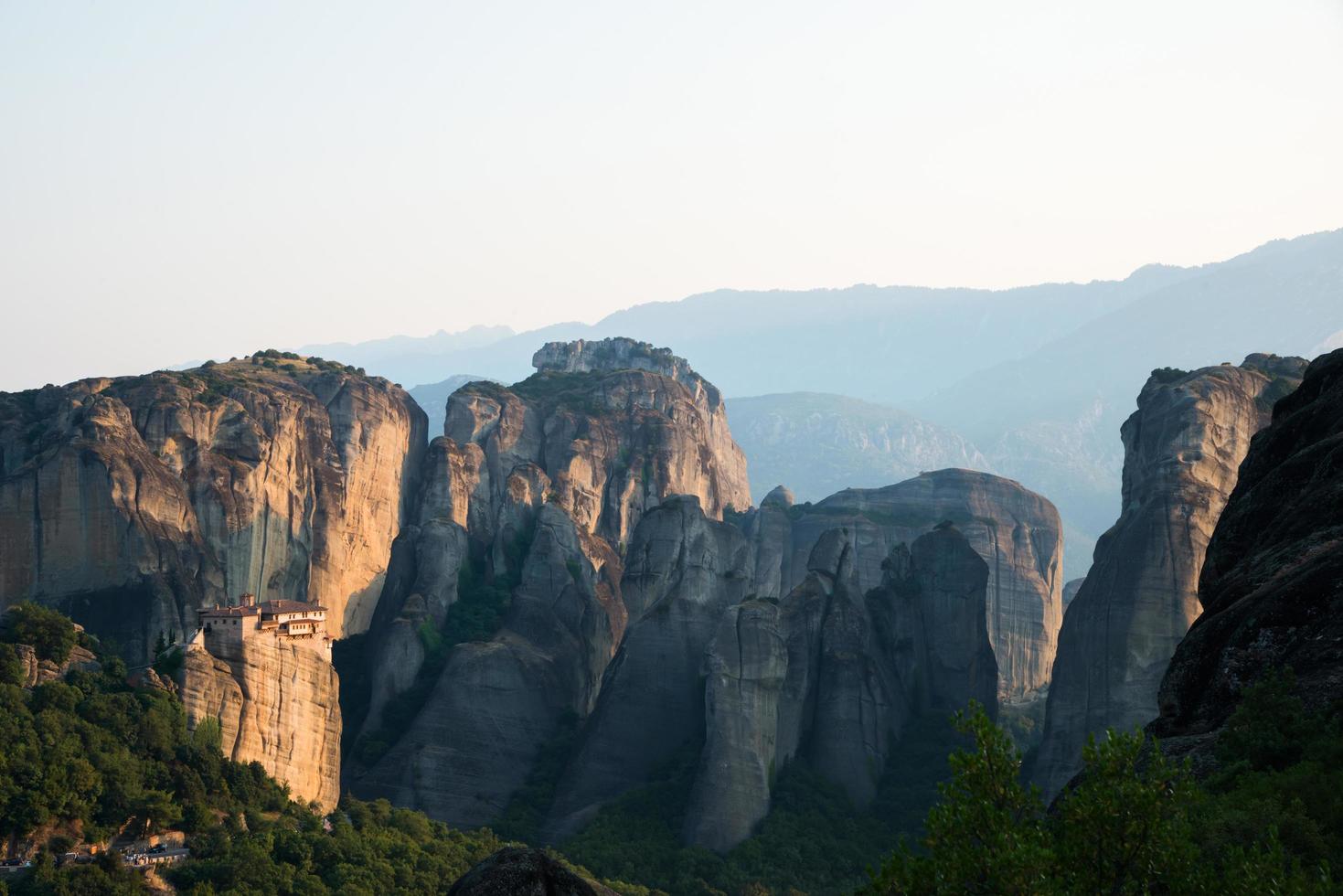 Impressive view of Meteora Mountains and Monastery close to sunset photo