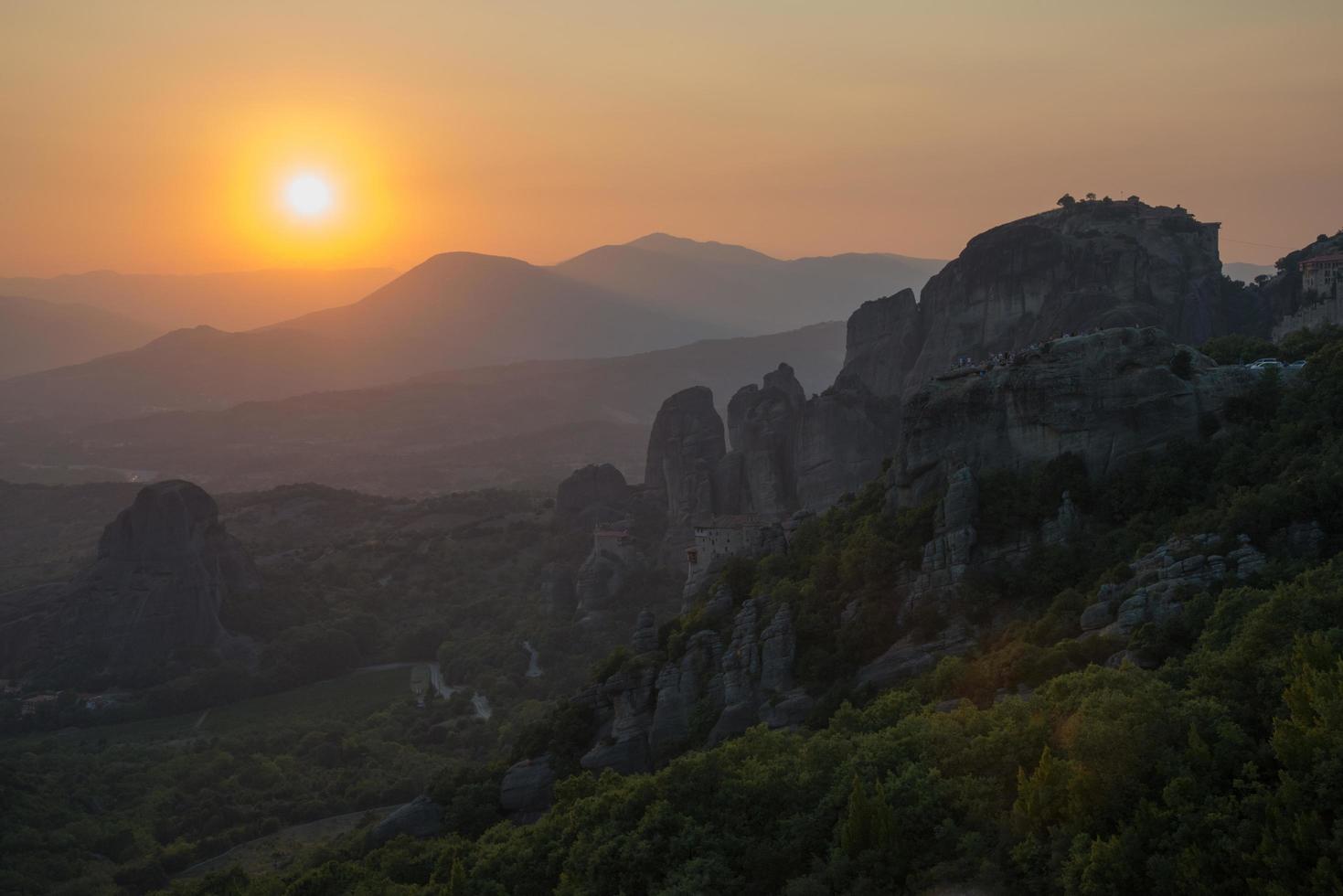 Beautiful view of Meteora Mountains and Monasteries at sunset photo