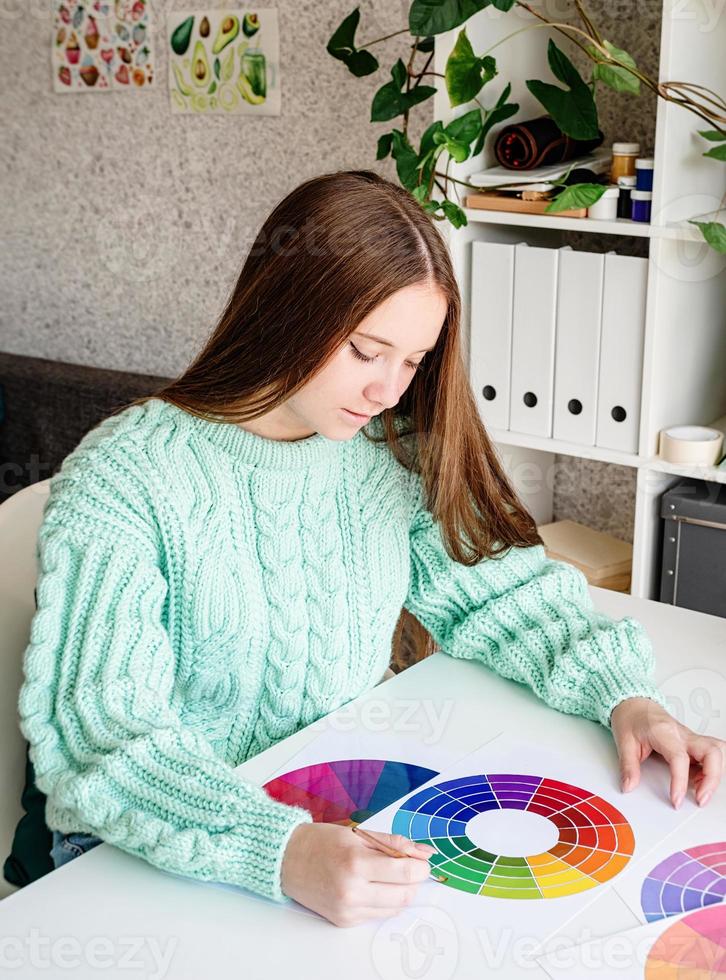 Designer or artist working with color samples and color wheel high angle view photo