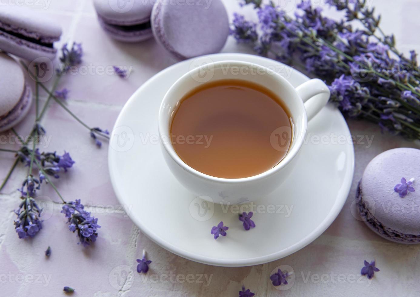 Cup of tea with macaroon dessert with lavender flavor photo