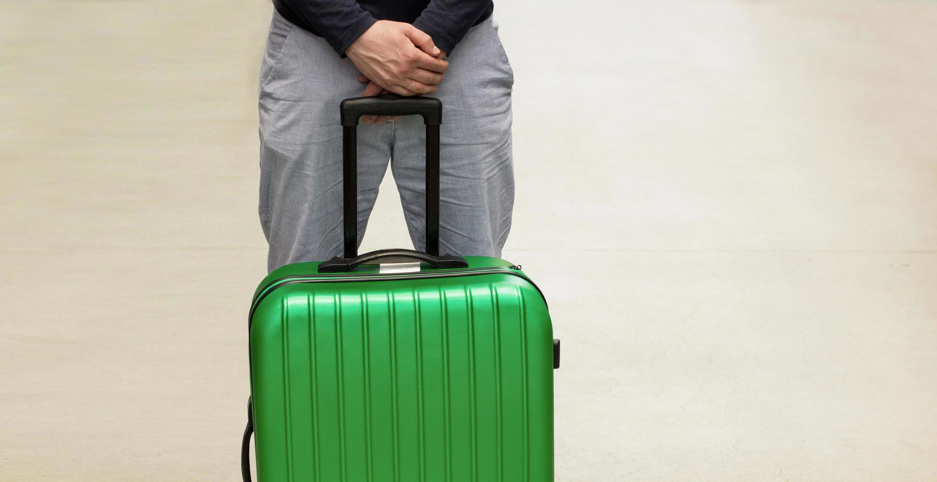 A man is waiting for deportation at the airport. Deporting of a foreign citizen. Voluntary departure and compulsory sending. Immigration and Emigration.Deport tourists.Selective focus, Copy space photo