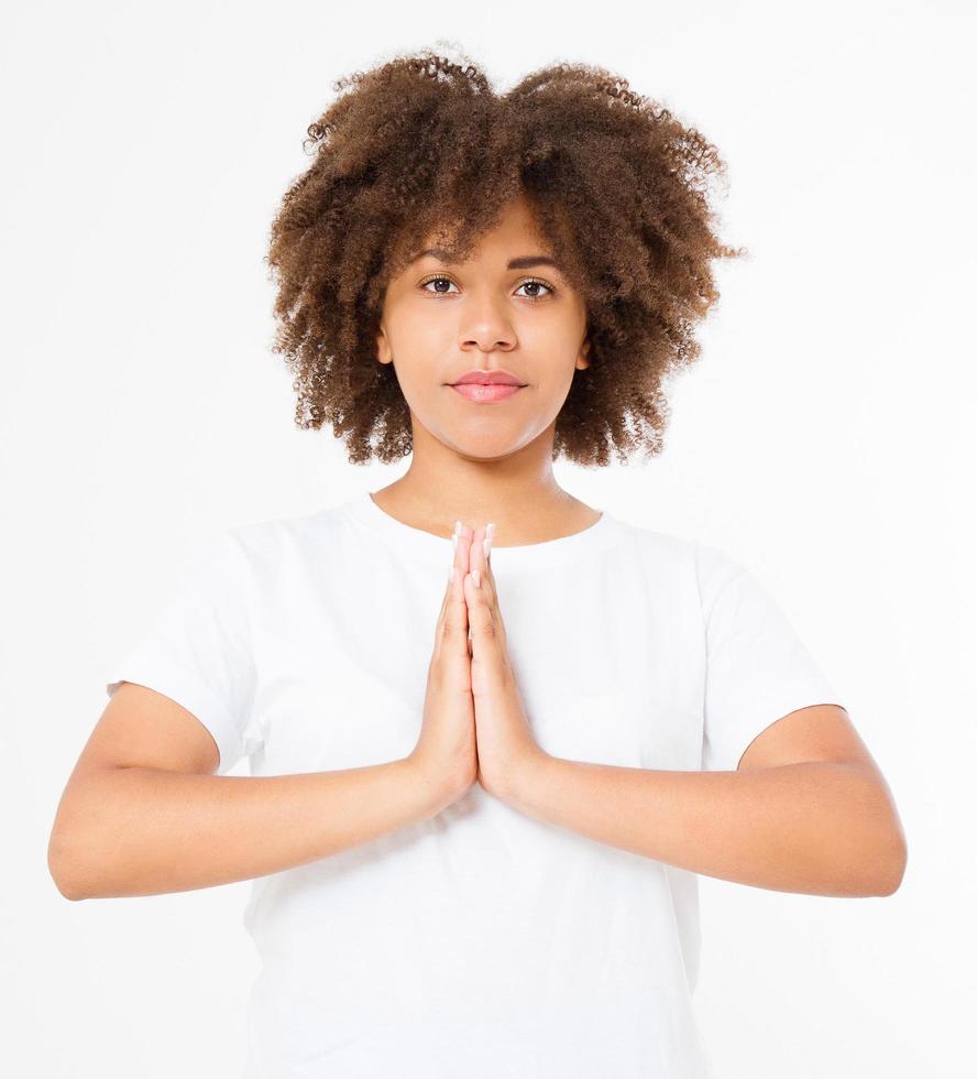 Close-up of hands of black, afro american woman in white clothes meditating indoors, focus on arms in Namaste gesture. Healthy lifestyle concept. Mock up. Copy space. Template. Blank. photo