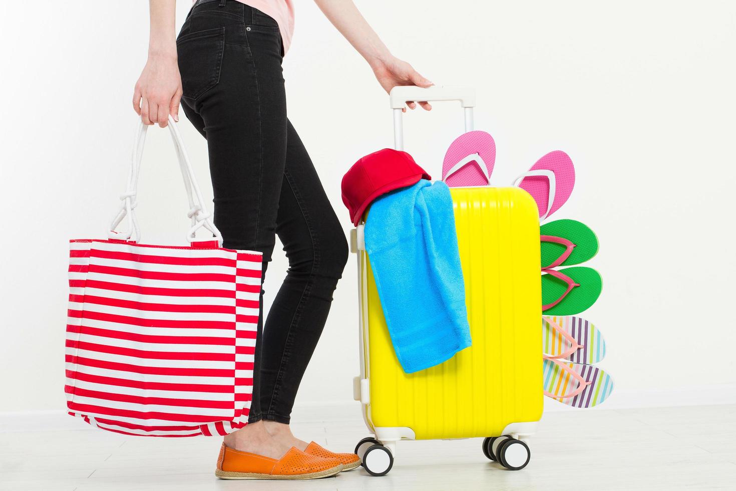 girl with suitcase isolated on white background .Summer holidays. summer flip flops or slippers. Travel valise or bag. Mock up. Copy space. Template. Blank. photo