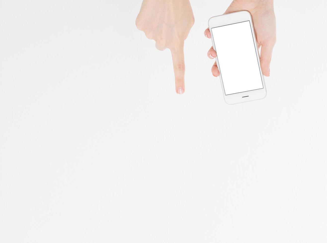 Hand holding white cellphone isolated on white clipping path inside. Online shopping. Top view. Mock up. Copy space. Template.Blank. photo