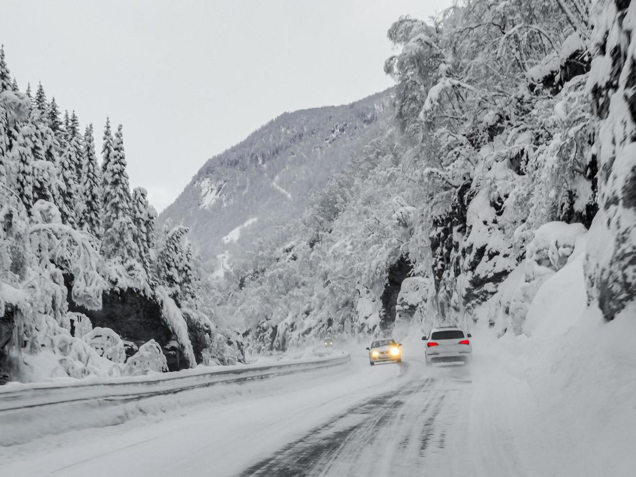 Driving through snowy road and landscape in Norway. photo