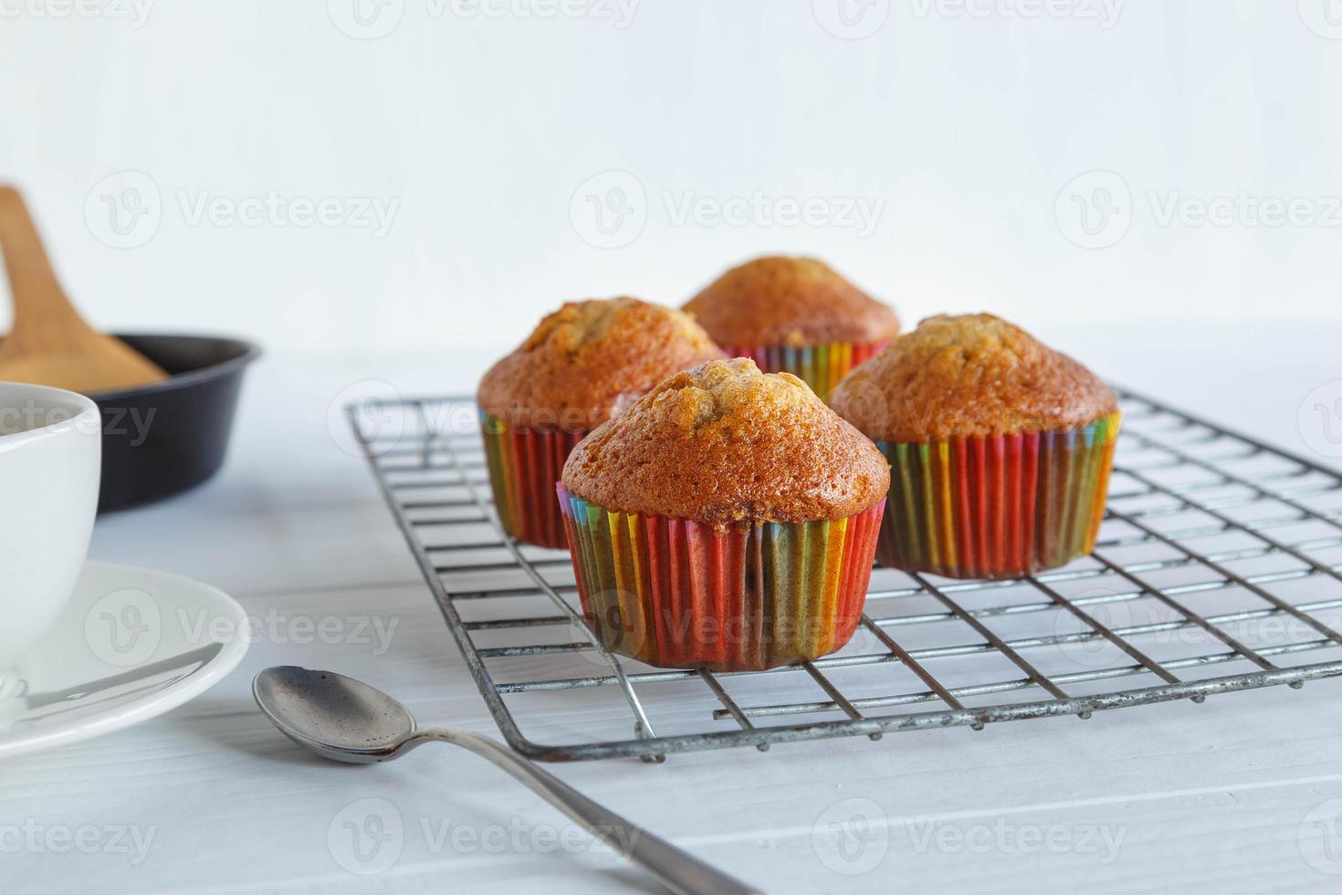 Home made cupcakes  and coffee cup on white table photo