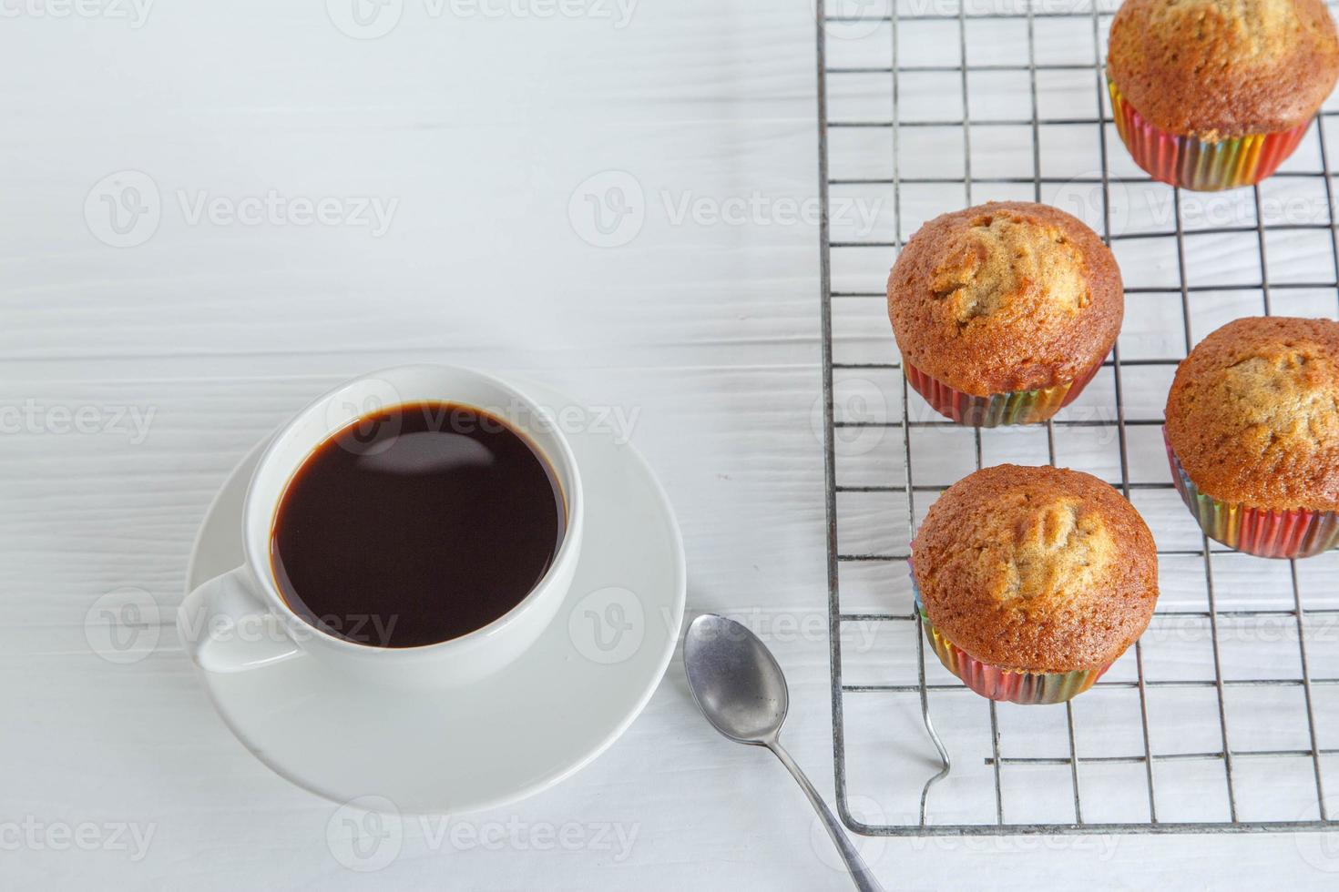 Home made cupcakes  and coffee cup on white table photo