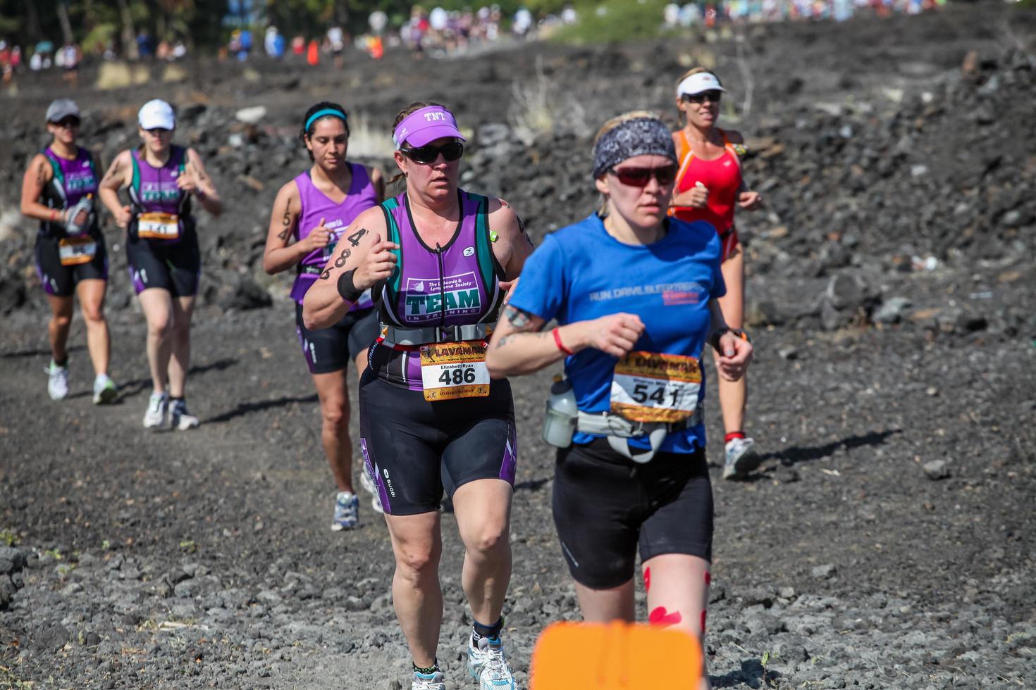 WAIKOLOA, USA, APRIL 3, 2011 - Unidentified runners on the Lavaman Triathlon in Waikoloa, Hawaii. It is held in Olympics format - 1.5 km swimming, 40 km biking and 10 km running. photo