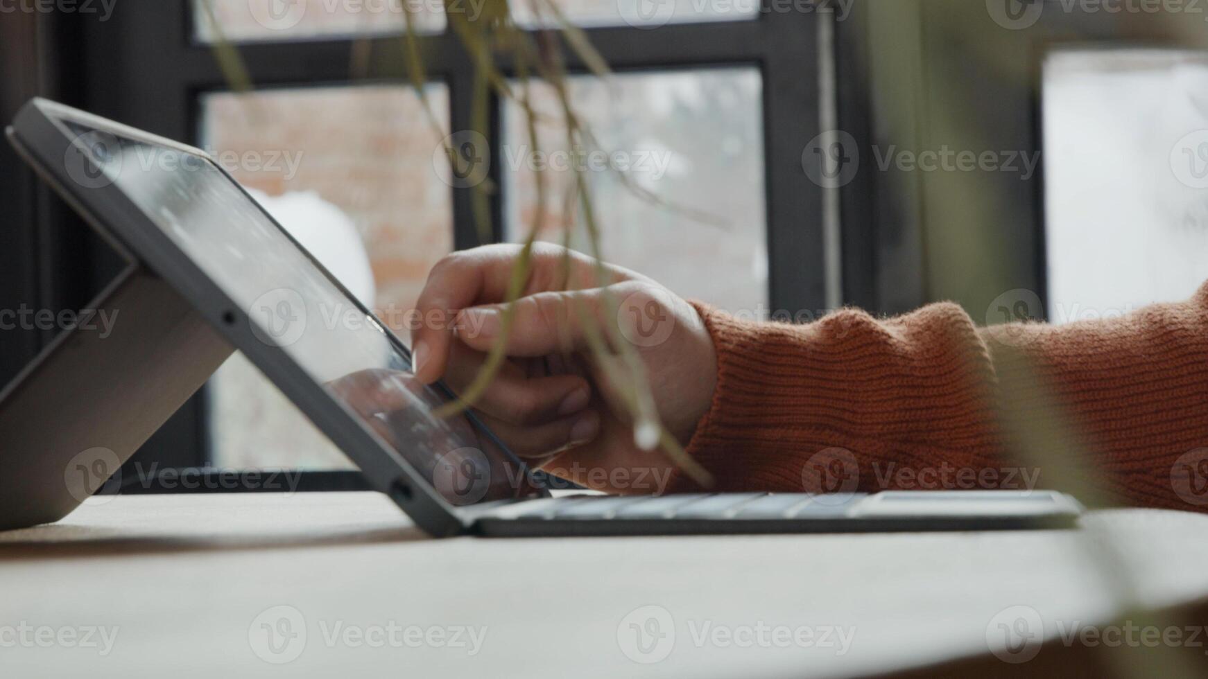 Close up of hand of young Middle Eastern man and laptop on table, finger touches screen photo