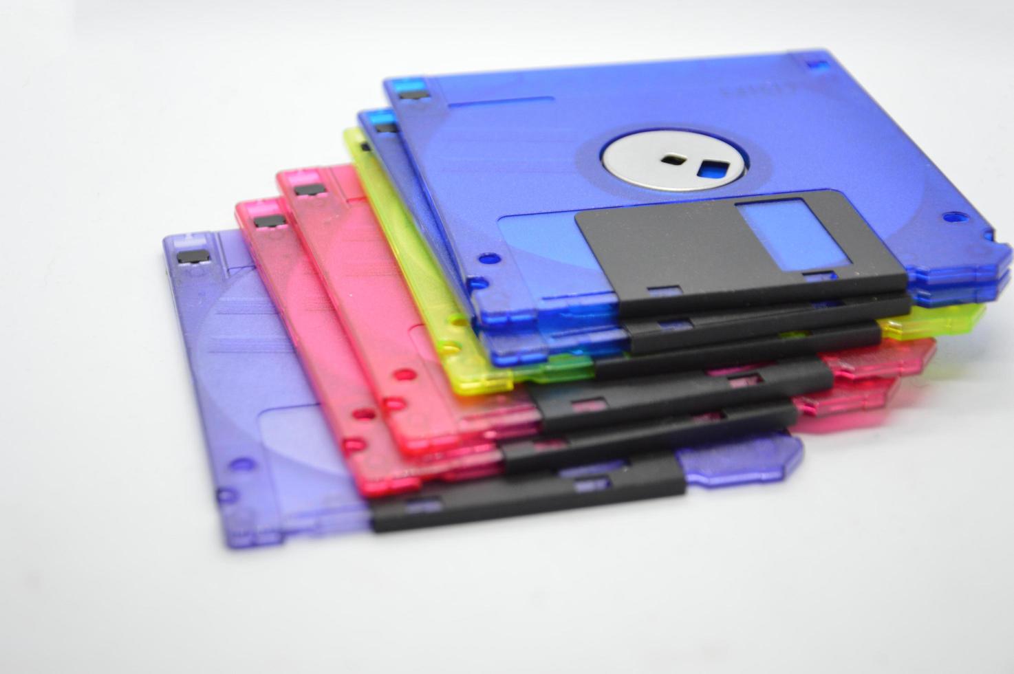 Retro media discs and floppy disks on a white background photo