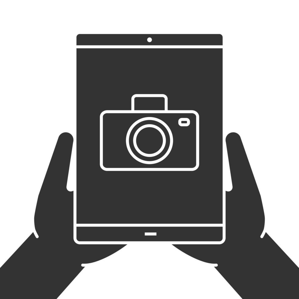 Hands holding tablet computer glyph icon. Photos view. Silhouette symbol. Tablet computer with camera. Negative space. Vector isolated illustration