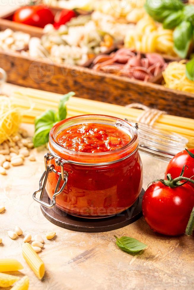 Glass jar with homemade classic spicy tomato pasta or pizza sauce. photo