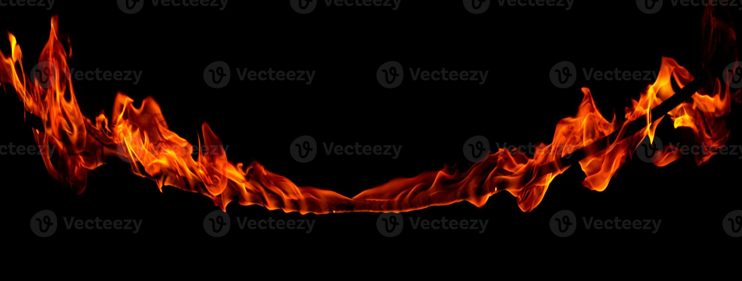 On fire flames at the black background, Burning red hot sparks rise, Fiery orange glowing flying particles photo