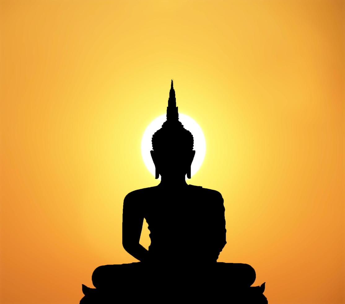 Silhouette of buddha and sunset background with blur motion photo