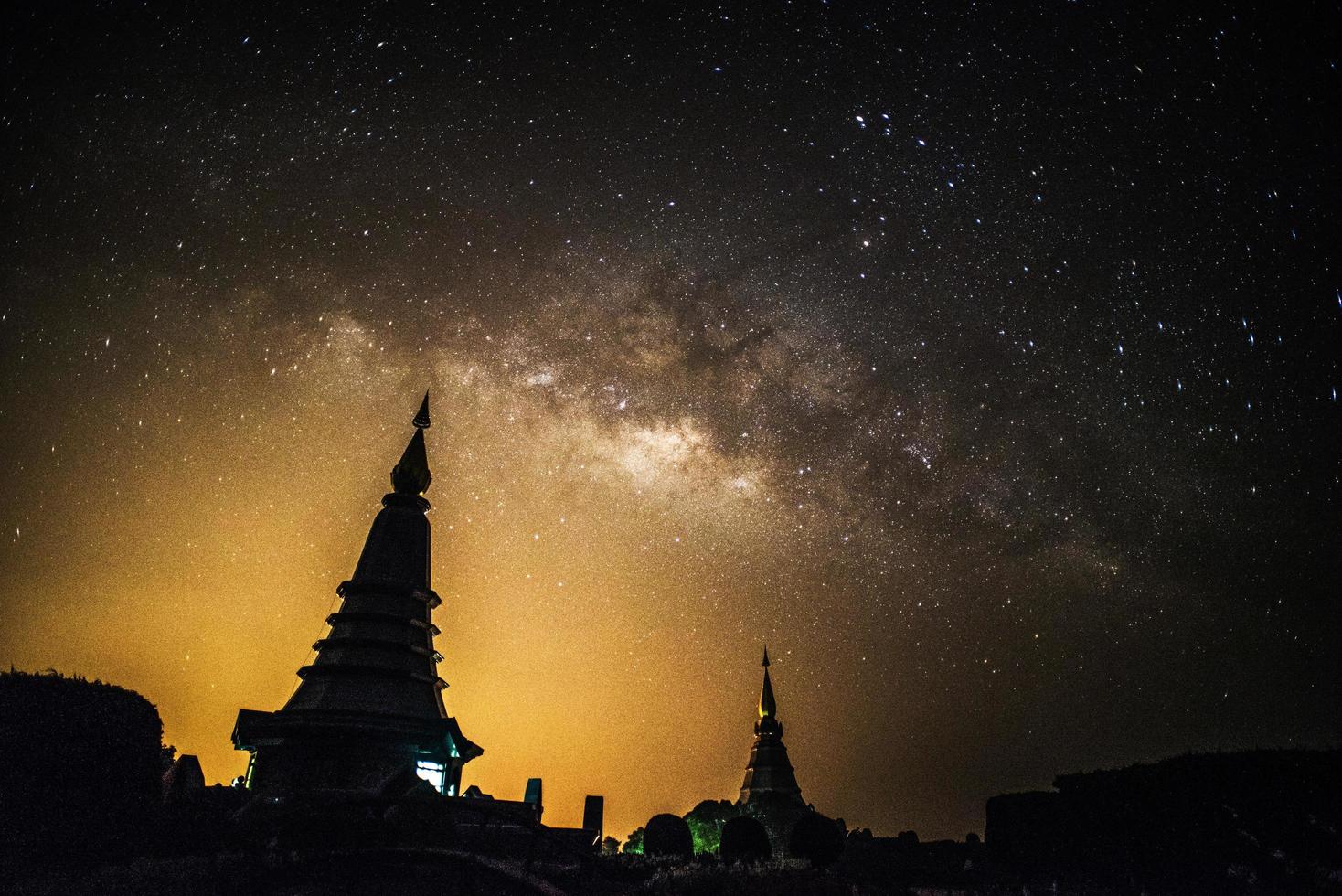 Milky Way Galaxy at Night above Pagoda silhouette in Thailand. photo