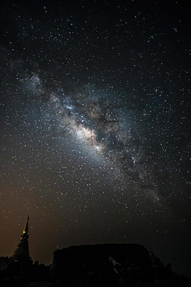 Milky Way Galaxy at Night above Pagoda silhouette in Thailand. photo