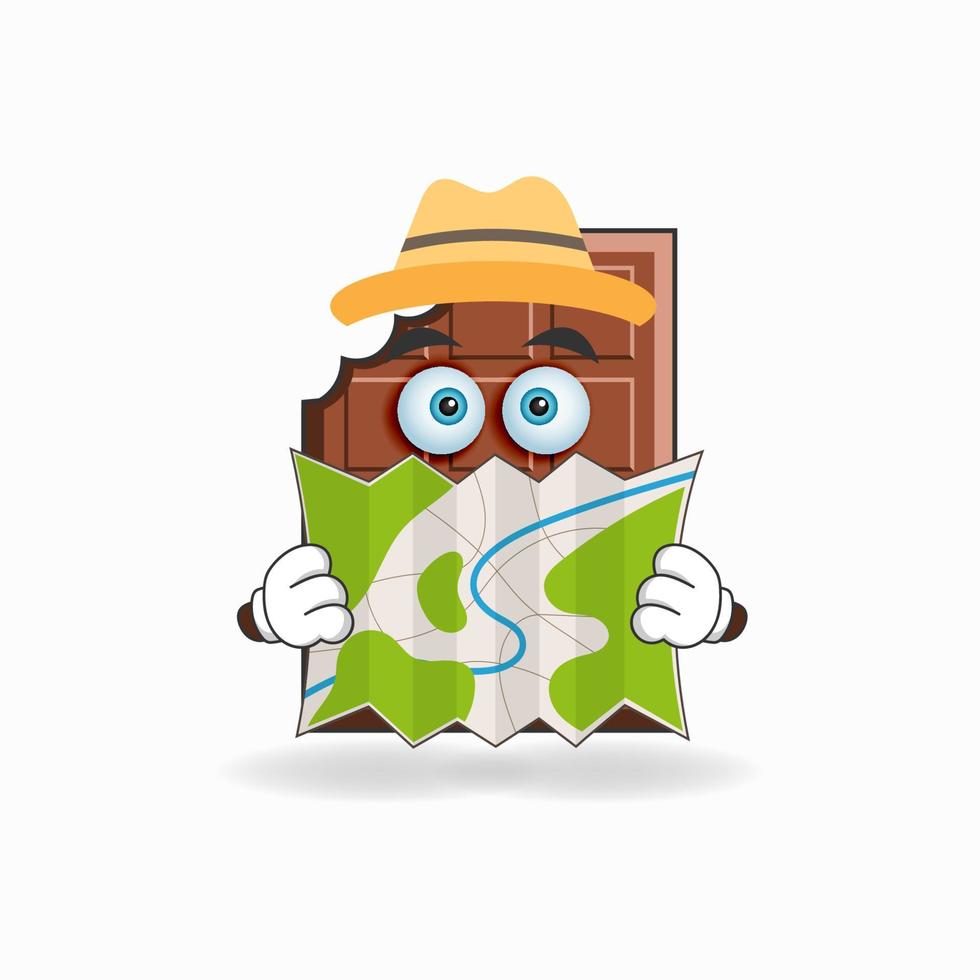 el personaje de la mascota del chocolate sostiene un mapa. ilustración vectorial vector