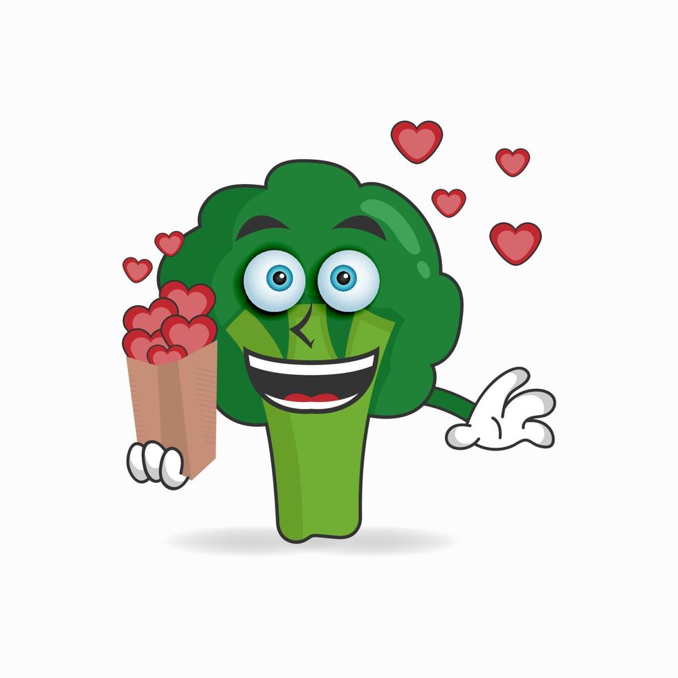 Personaje de mascota de brócoli sosteniendo un icono de amor. ilustración vectorial vector