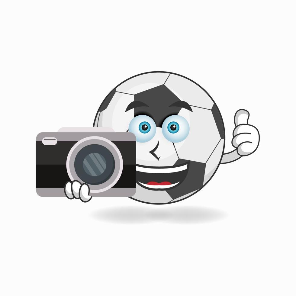 Soccer Ball mascot character holding camera. vector illustration