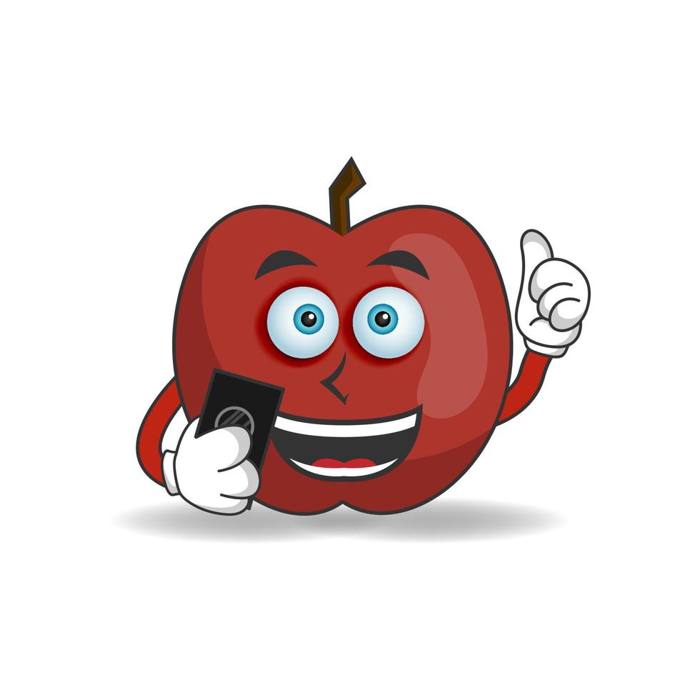 personaje de mascota de manzana sosteniendo un teléfono celular. ilustración vectorial vector