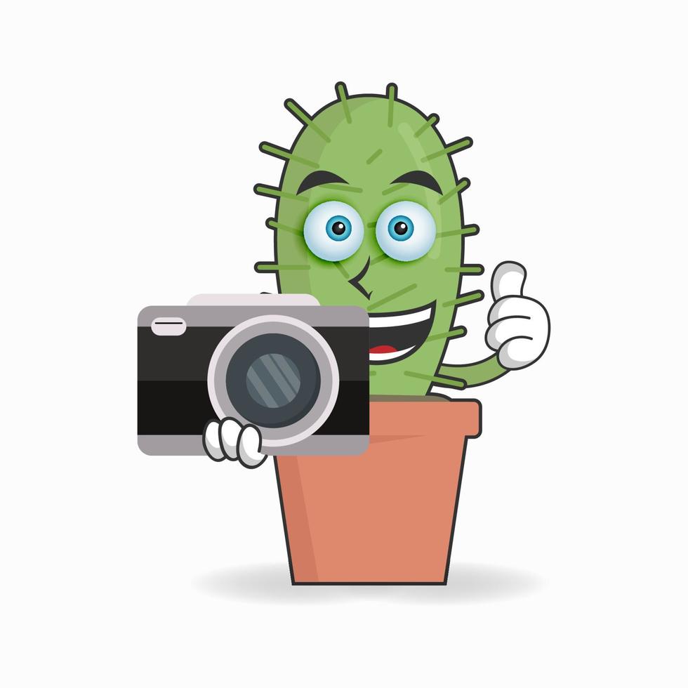 Cactus mascot character holding camera. vector illustration
