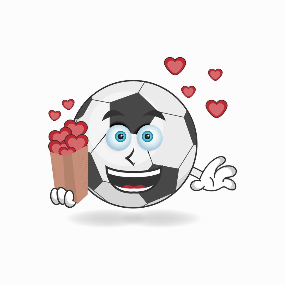 personaje de mascota de balón de fútbol sosteniendo un icono de amor. ilustración vectorial vector