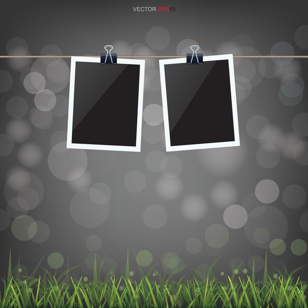 Blank photo frame in green grass field and light blurred bokeh background. Vector. vector