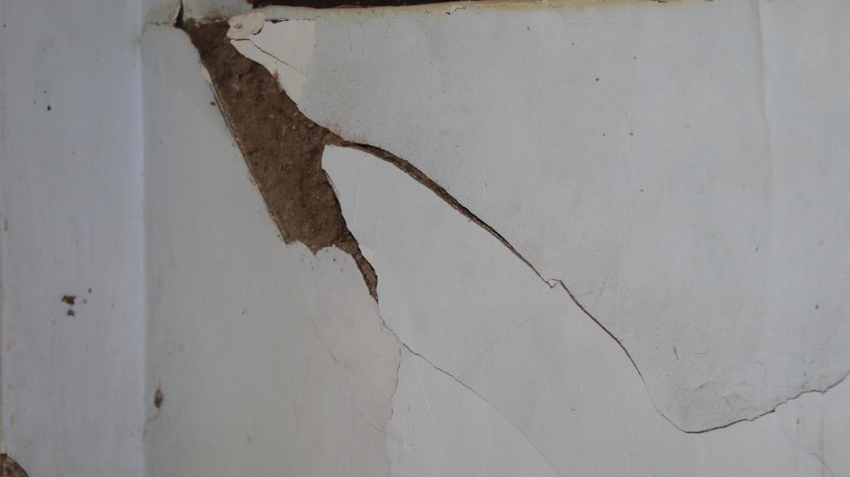 cement wall collapse. Cracked concrete old wall. dangerous, damaged building structure. photo