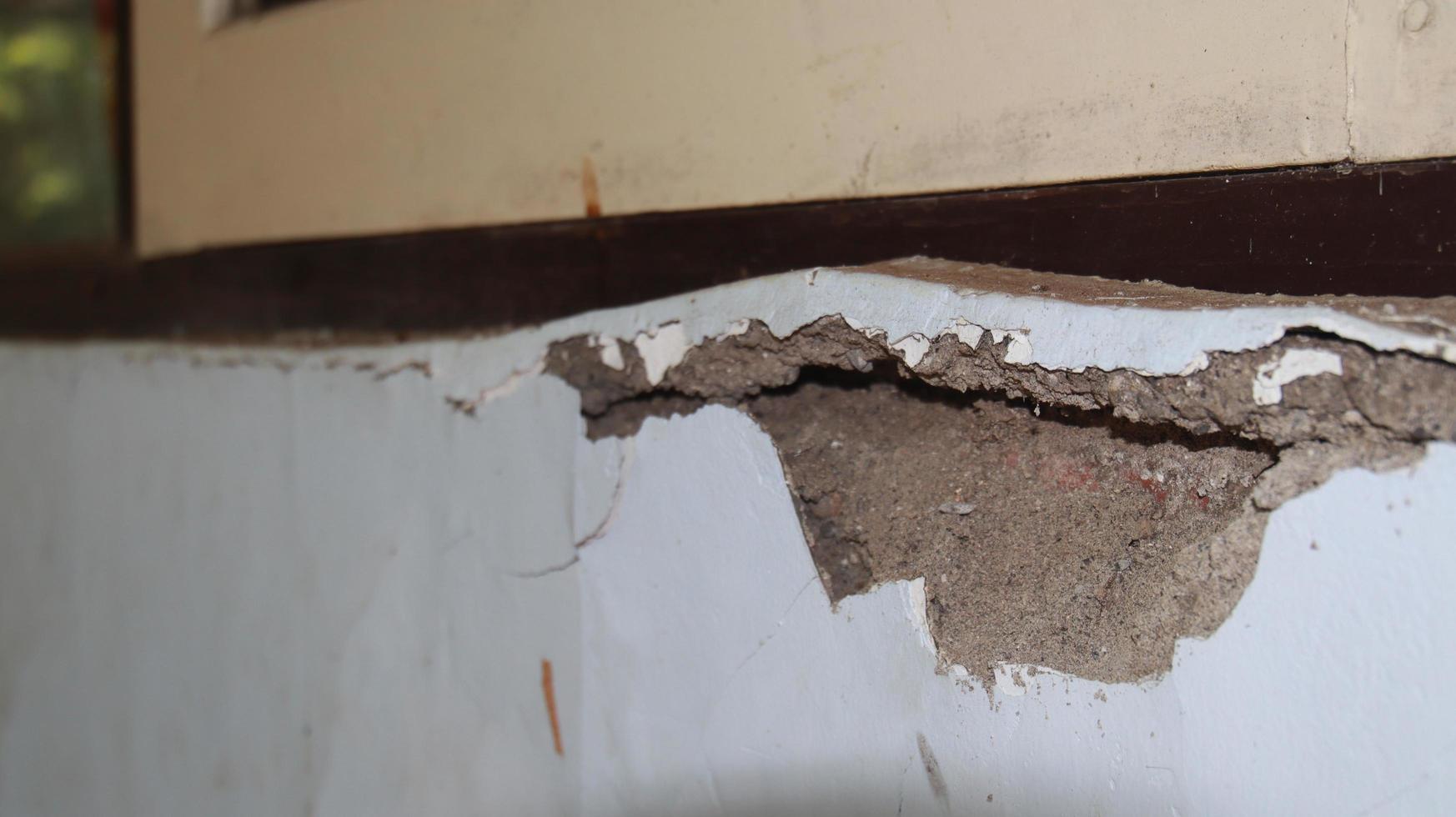 cement wall collapse. Cracked concrete old wall. dangerous, damaged building structure. photo