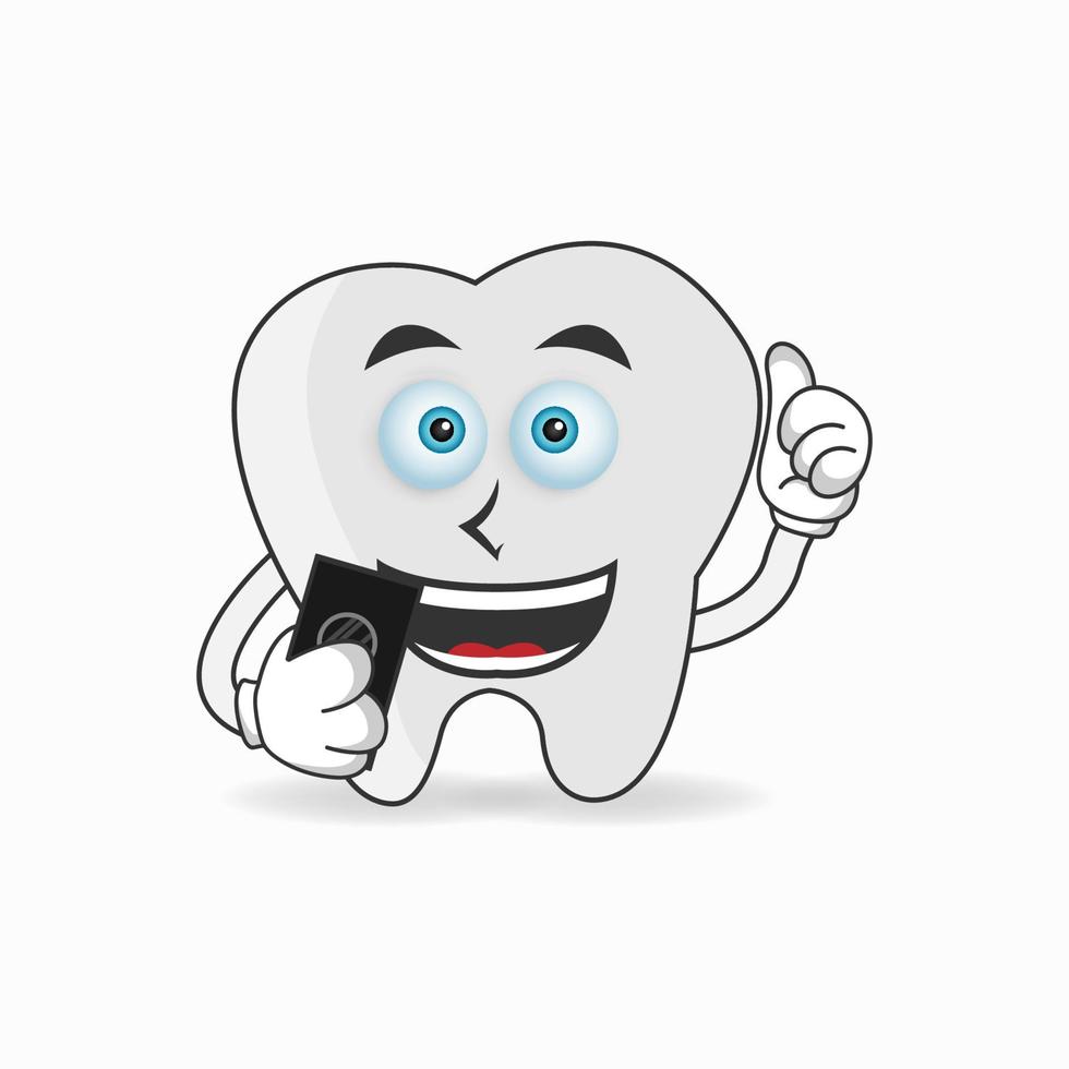Tooth mascot character holding a cellphone. vector illustration