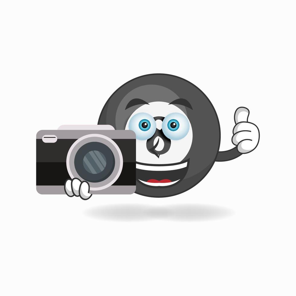 Billiard ball mascot character holding camera. vector illustration