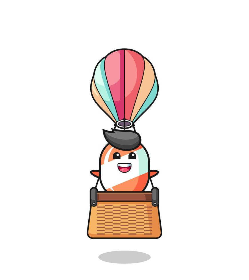 candy mascot riding a hot air balloon vector