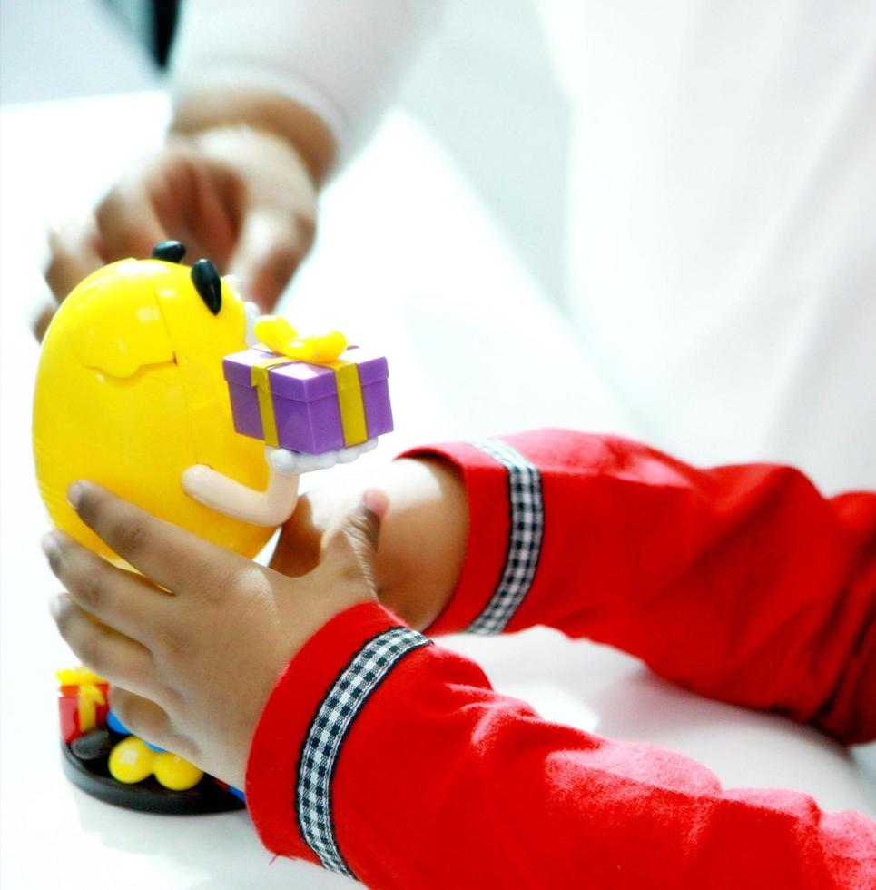 Child playing with colorful toy with mom photo