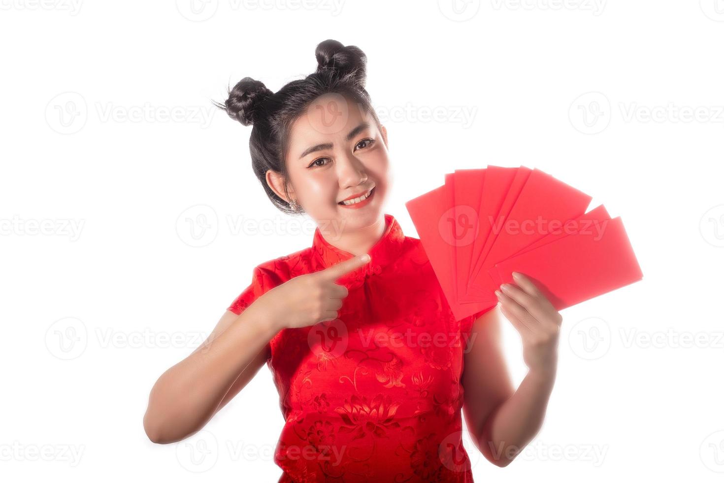 Portrait Asian woman red dress traditional cheongsam holding red envelopes at white background photo