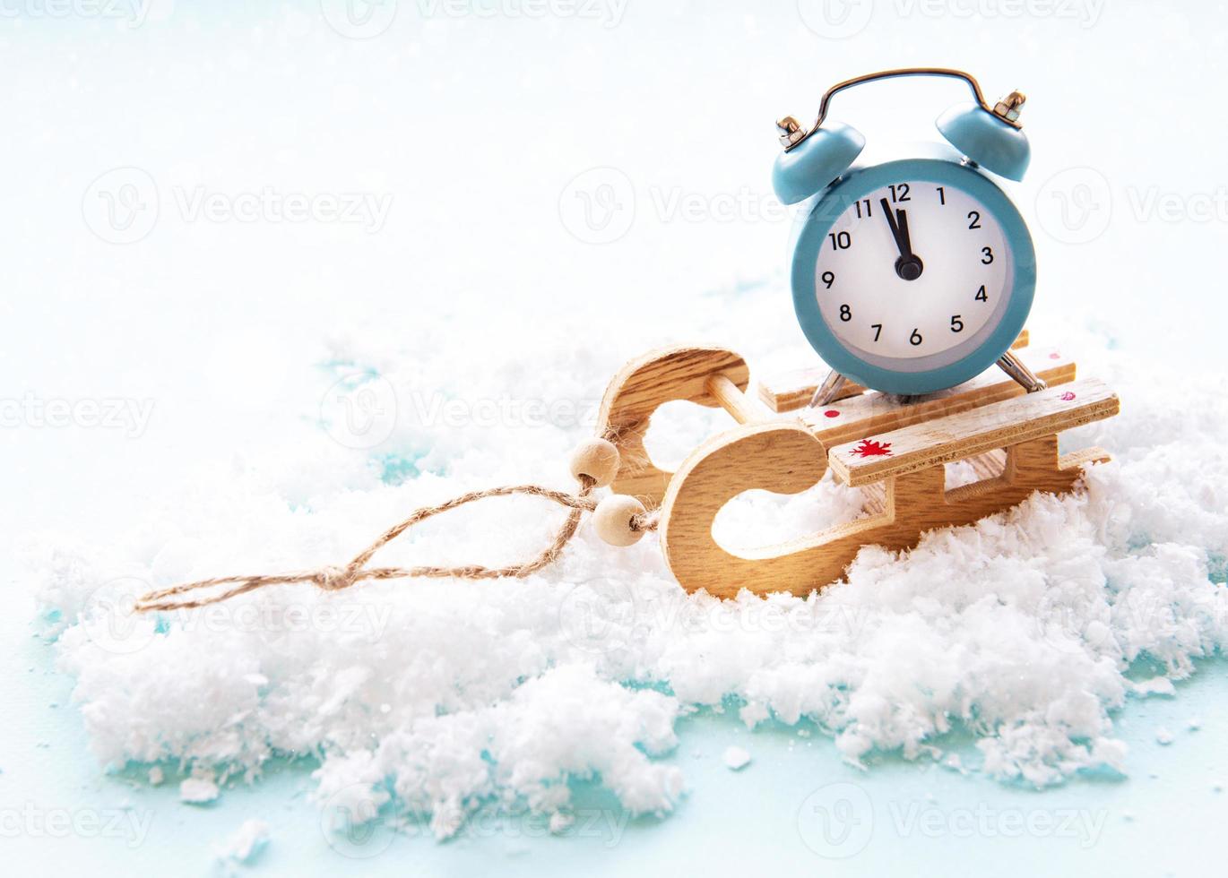 Christmas alarm clock on a toys sled photo