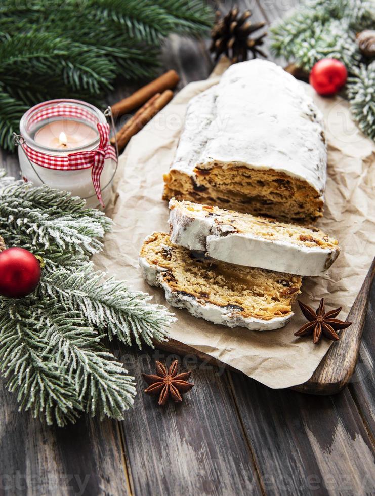 Christmas stollen on wooden background photo