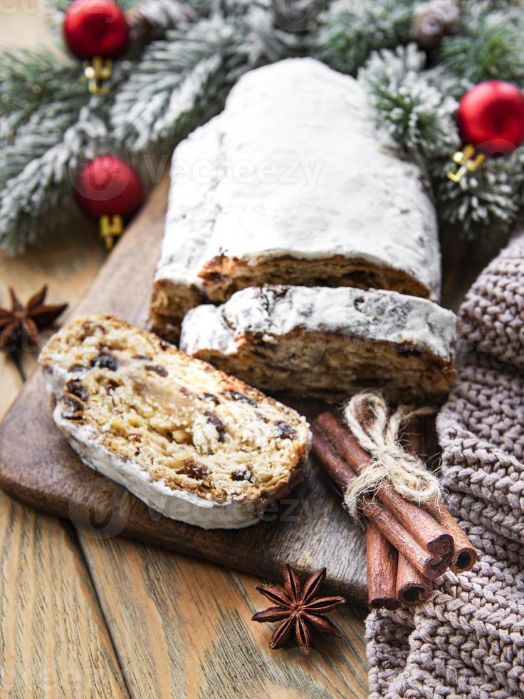 Christmas stollen on wooden background photo