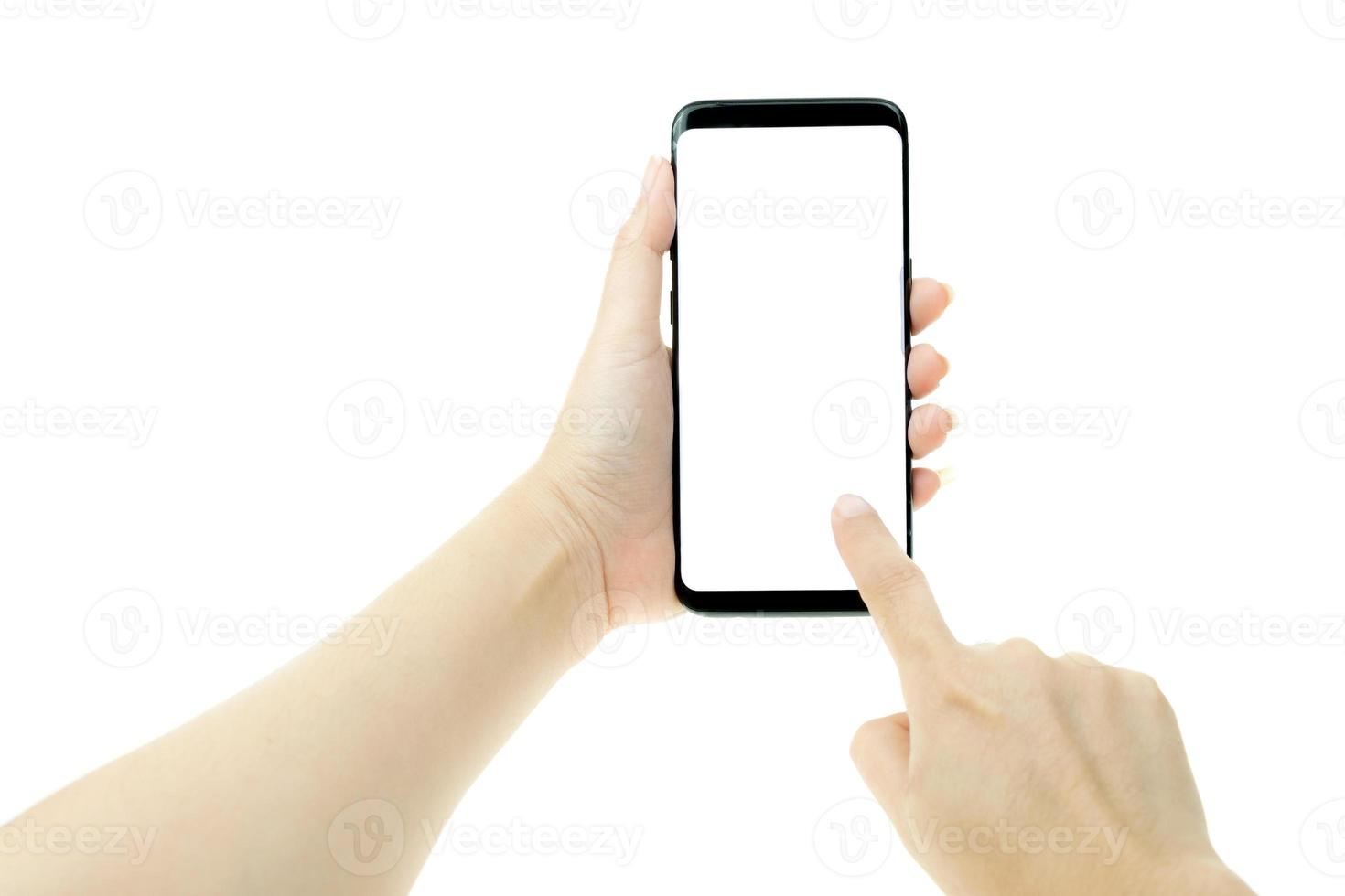 Woman hand holding black mobile phone with white screen at the background photo