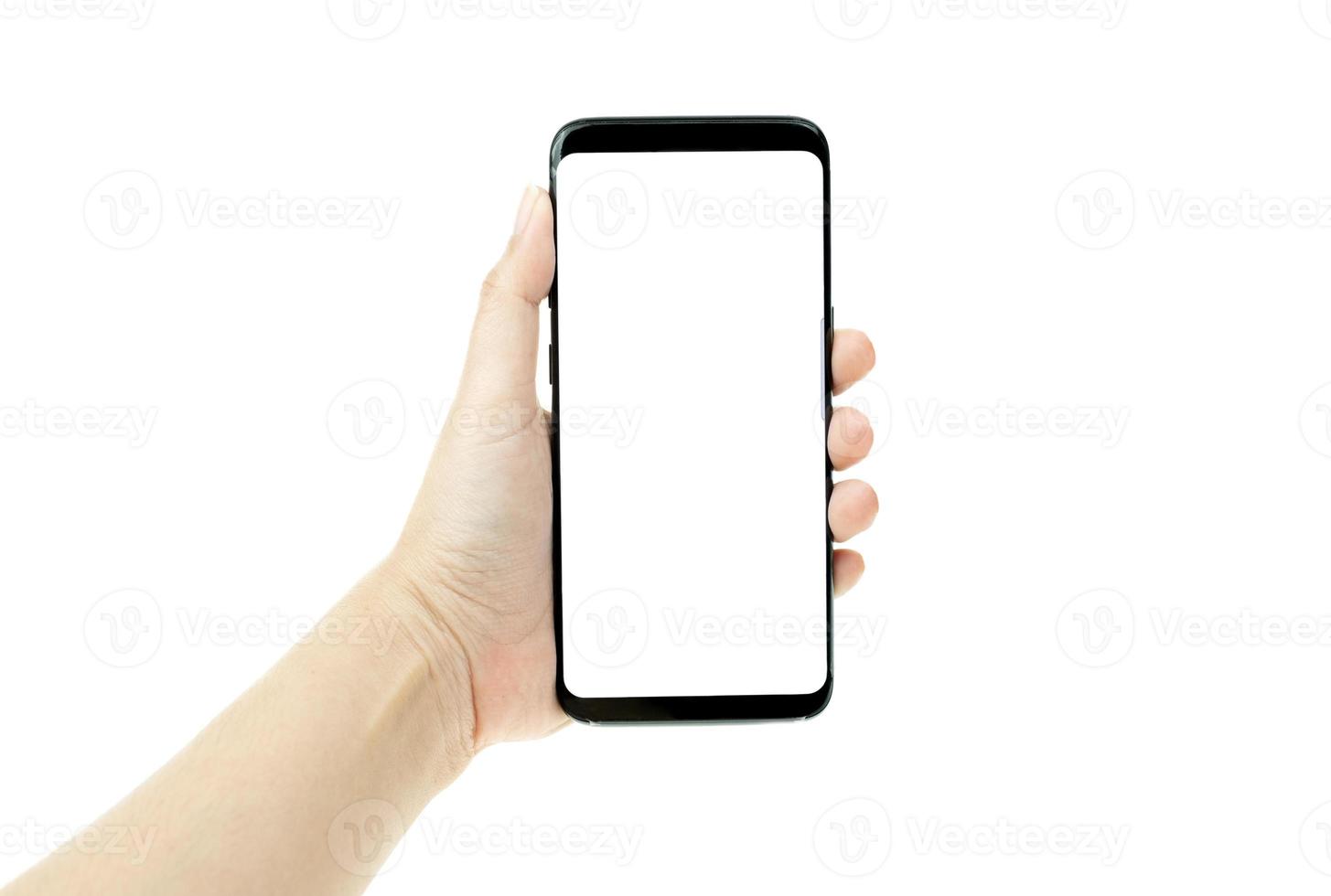 Woman hand holding black mobile phone with white screen at the background photo