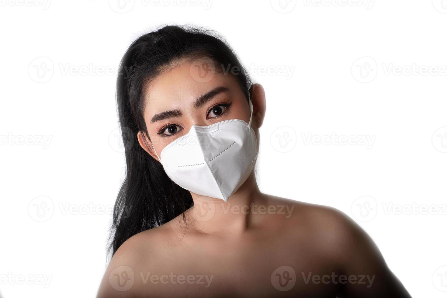 Close up of a woman putting on a respirator N95 mask to protect from airborne respiratory diseases as the flu covid-19 coronavirus ebola PM2.5 dust and smog photo