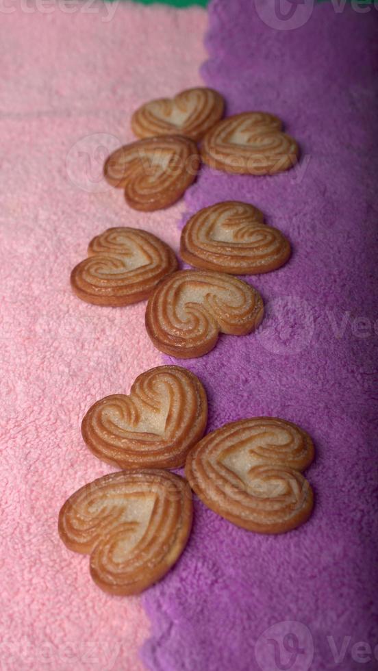 Delicious homemade heart shaped cookie on a color background. Top View. Place for text. photo