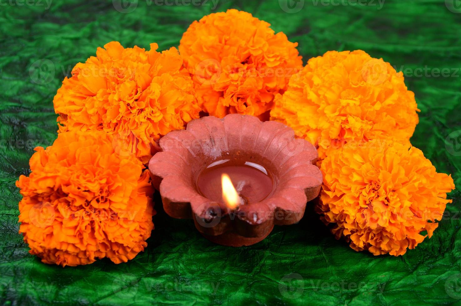 Happy Diwali - Diya lamps lit during Diwali celebration. Colourful and decorated lantern are lit in night on this occasion with flower Rangoli, sweets and gifts. photo