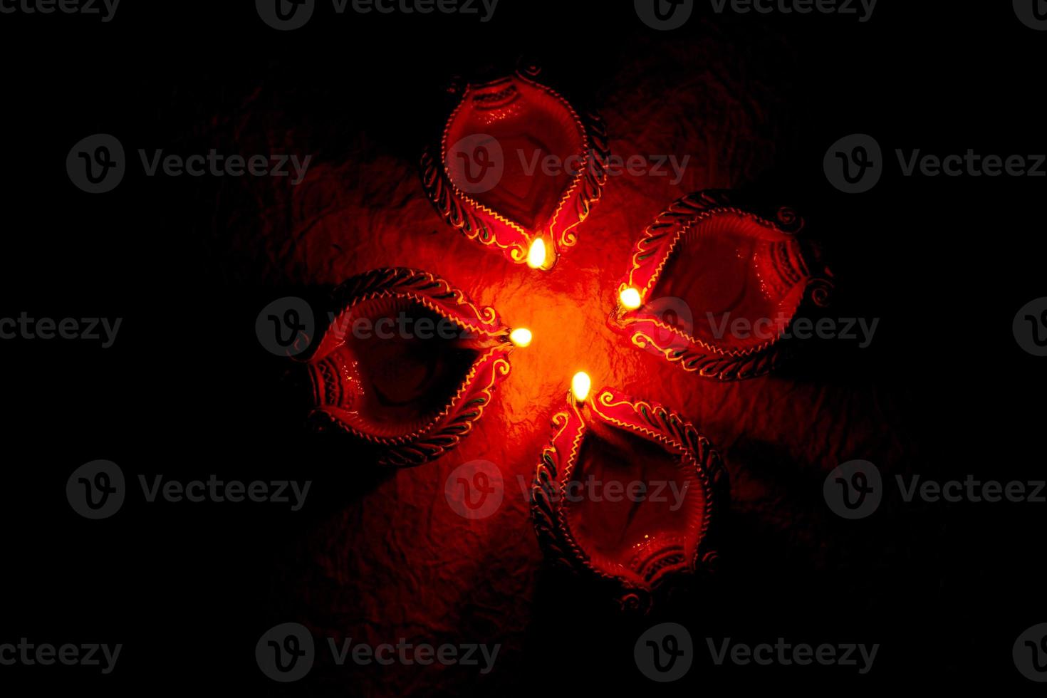 Happy Diwali - Diya lamps lit during Diwali celebration. Colourful and decorated lantern are lit in night on this occassion with flower rangoli, sweets and gifts. photo
